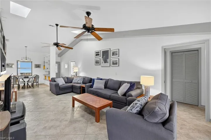 Living area featuring a skylight and vaulted ceiling