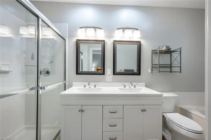 Upstairs Primary bathroom with tub, shower stall and dual sinks.