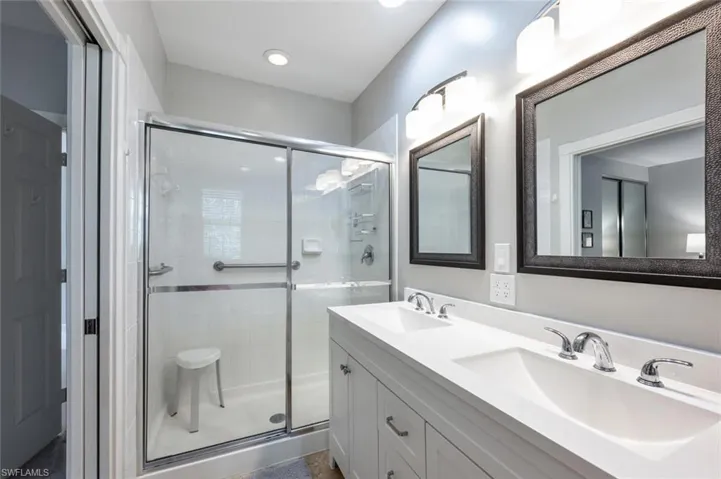 Upstairs Primary bathroom featuring vanity and an enclosed shower