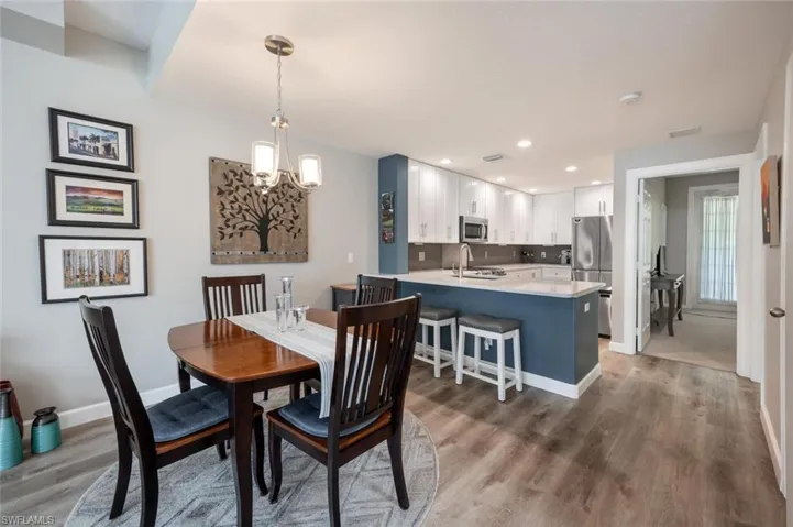 Dining area with open concept kitchen and breakfast nook.