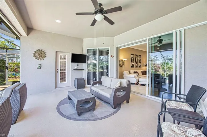 View of patio / terrace with a lanai, a sunroom, ceiling fan, and outdoor lounge area
