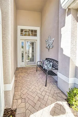 Entrance to property with a patio area, stucco siding, and french doors