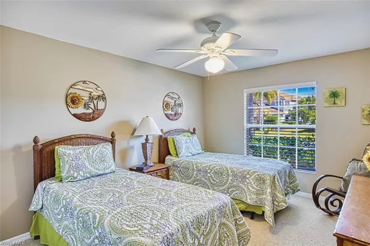 Carpeted bedroom with baseboards and ceiling fan