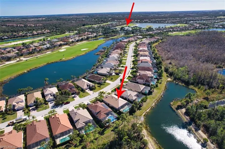 View of property location featuring a nearby body of water, a golf course, and nearby suburban area