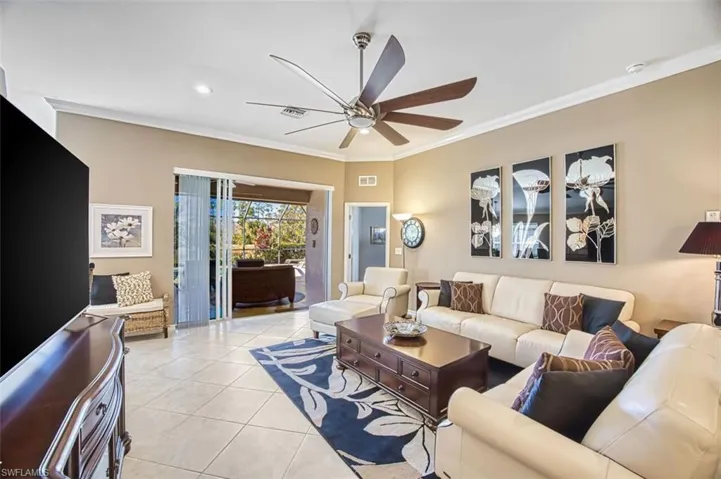 Living area with crown molding, tile patterned flooring, a ceiling fan, and recessed lighting