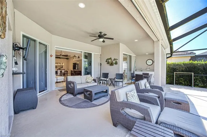 View of patio featuring a lanai, an outdoor hangout area, ceiling fan, and a sunroom