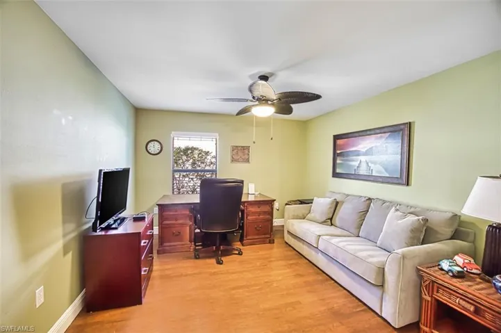 Office space with light wood-style floors and ceiling fan