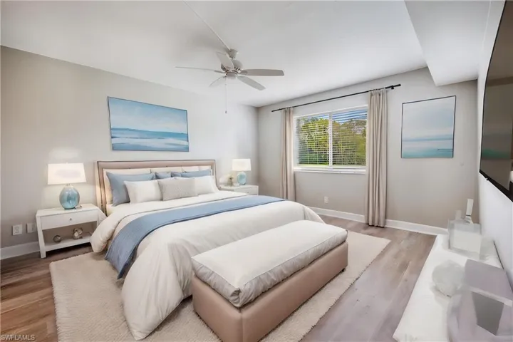 Bedroom with ceiling fan and light hardwood /wood-style floors virtually staged