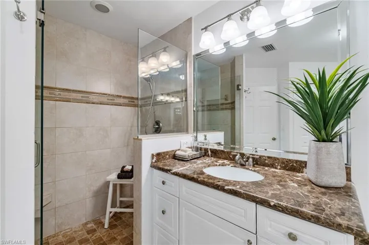 Full bathroom featuring vanity and a shower stall