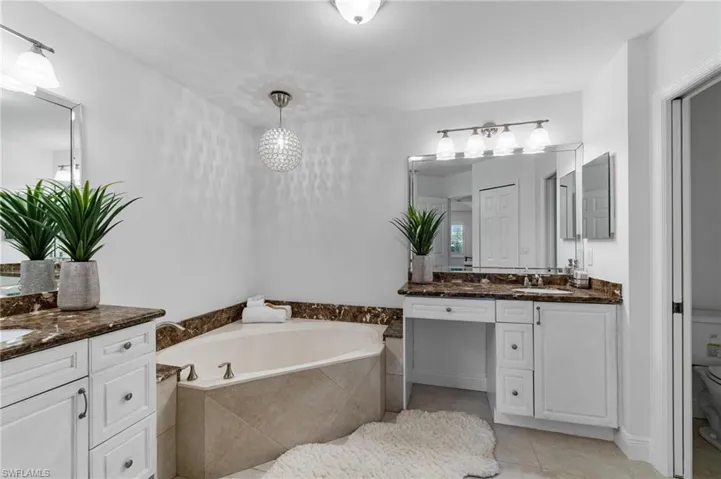 Dual sinks and a large garden tub awaits to offer relaxing moments free of stress