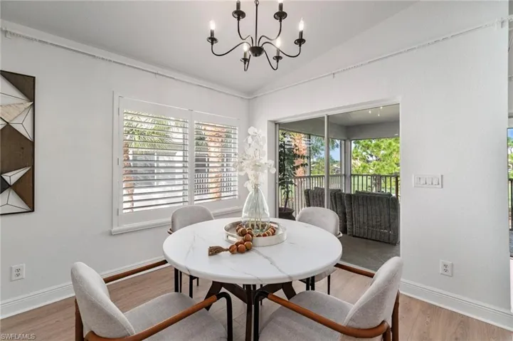 Dining space featuring custom light fixture and plenty of natural light