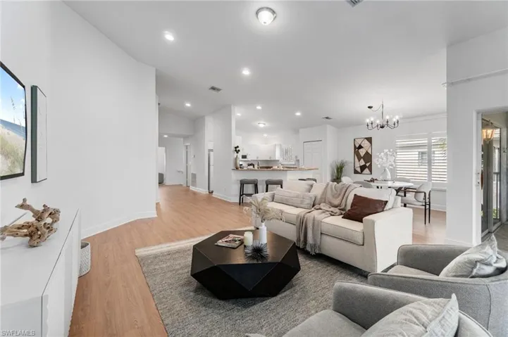 Filled with natural light, the open living area flows seamlessly into the kitchen and dining spaces.  Vaulted ceiling feels open and b spacious thru great area.
