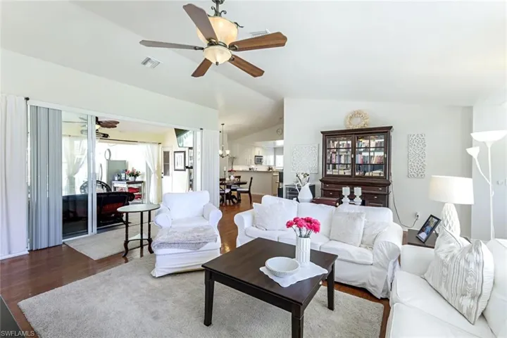 Living room with vaulted ceilings and hardwood floors