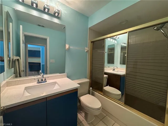 Bathroom featuring tile patterned floors and a shower stall