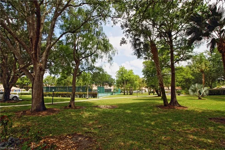 Plenty of green space  leading to tennis court