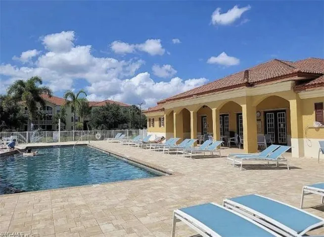 Community pool with a patio