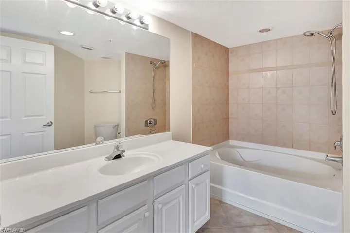 Full bath with vanity, shower / bathtub combination, and tile patterned floors