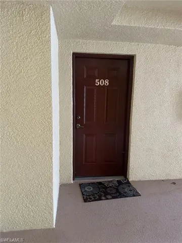 Entrance to property with stucco siding