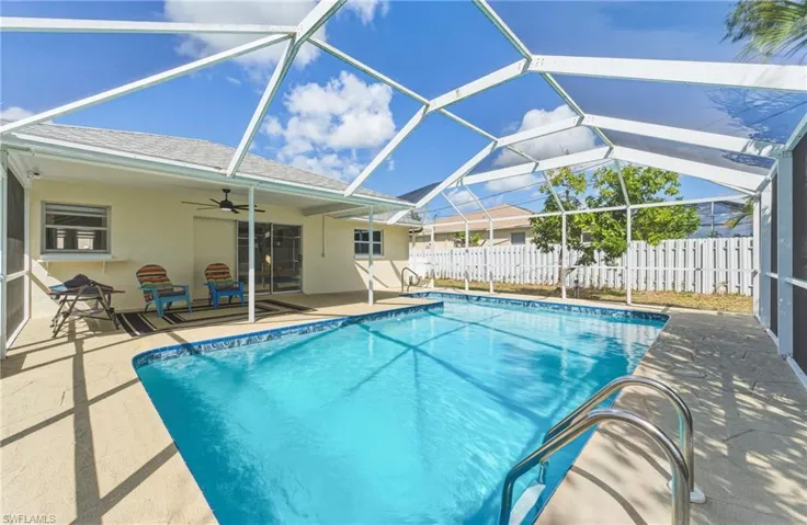 View of pool with a sunroom, patio surround, and glass enclosure