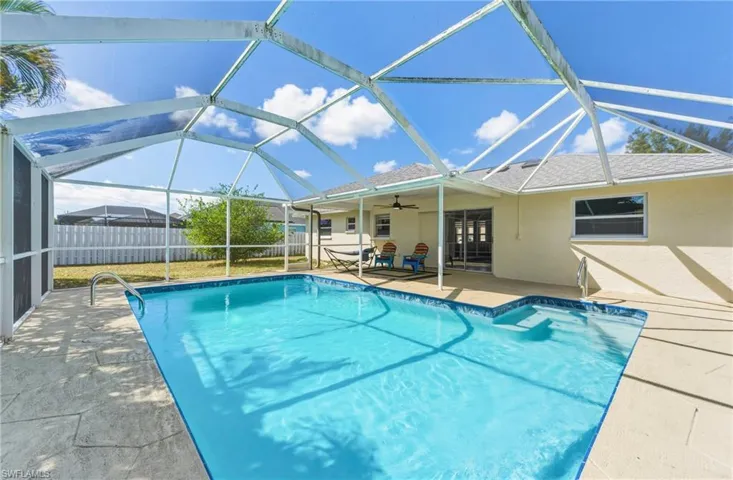 View of pool featuring patio surround, a lanai, and a sunroom
