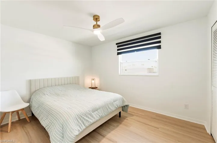 Bedroom featuring light wood finished floors and a ceiling fan