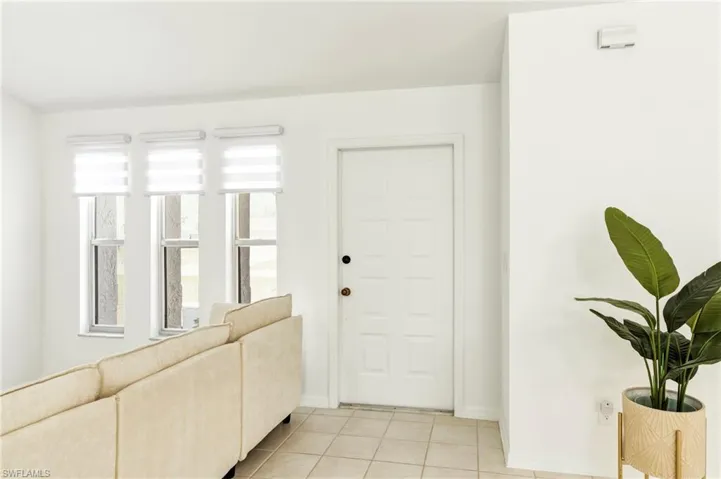 Entryway featuring light tile patterned floors and baseboards