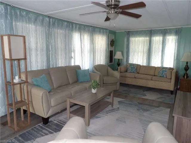Living area featuring ceiling fan and wood finished floors