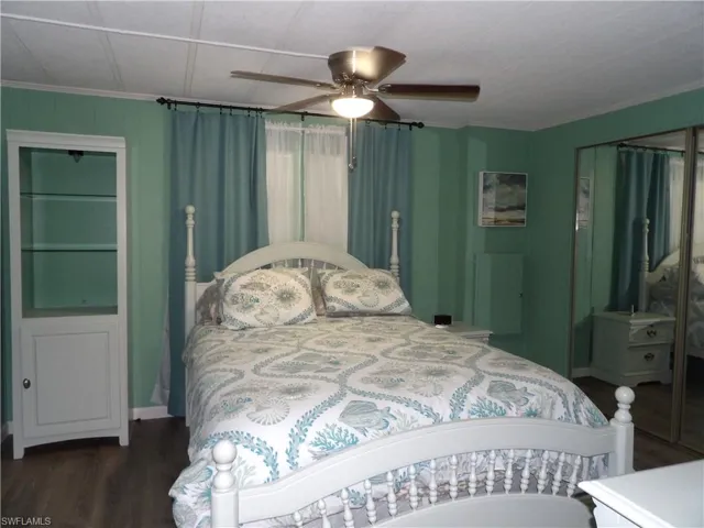 Primary Bedroom featuring luxury vinyl floors, spacious storage and a ceiling fan