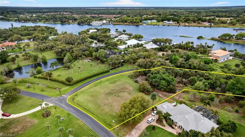 Aerial view of property's location with a large body of water and property boundaries highlighted