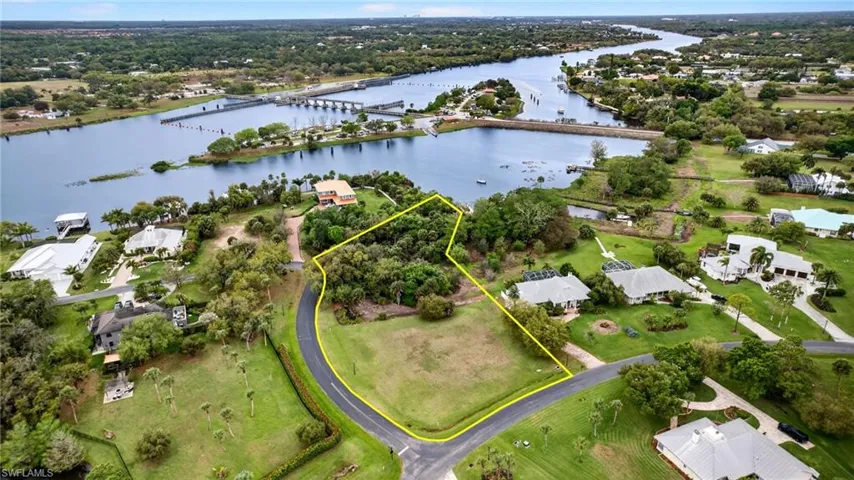 Aerial view of residential area with a notable bridge and a nearby body of water