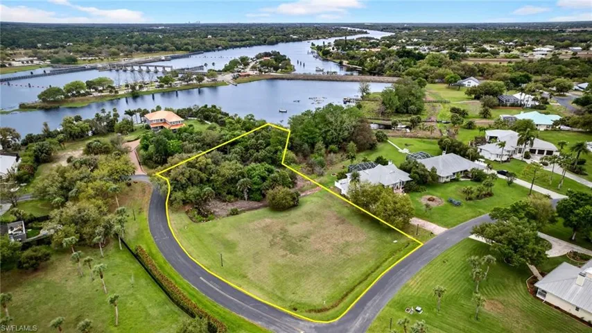 Aerial view of residential area featuring a notable bridge and a large body of water