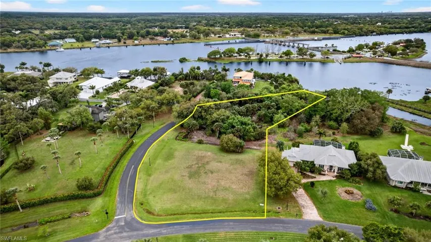 Aerial overview of property's location with property boundaries highlighted and a large body of water