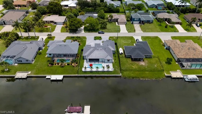 Aerial view of residential area featuring a large body of water