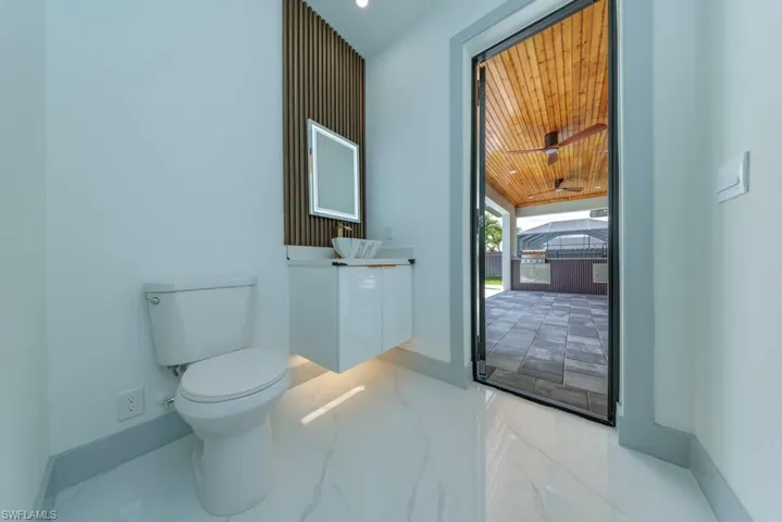 Half bathroom with vanity, wooden ceiling, and marble finish flooring