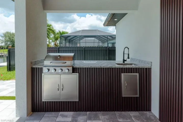 View of patio / terrace featuring a sink and an outdoor kitchen
