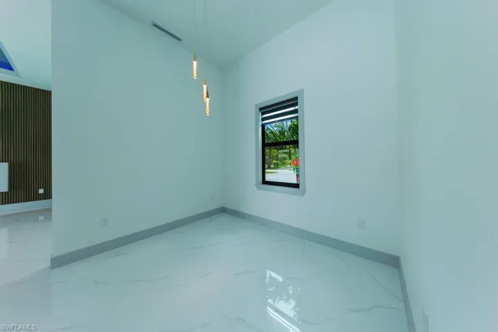 Spare room featuring marble finish floors