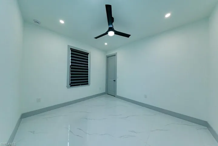 Spare room with light marble finish flooring, recessed lighting, a ceiling fan, and a smoke detector
