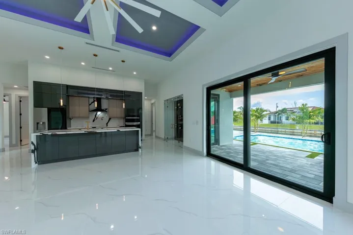 Unfurnished living room with recessed lighting, light marble finish flooring, and a ceiling fan