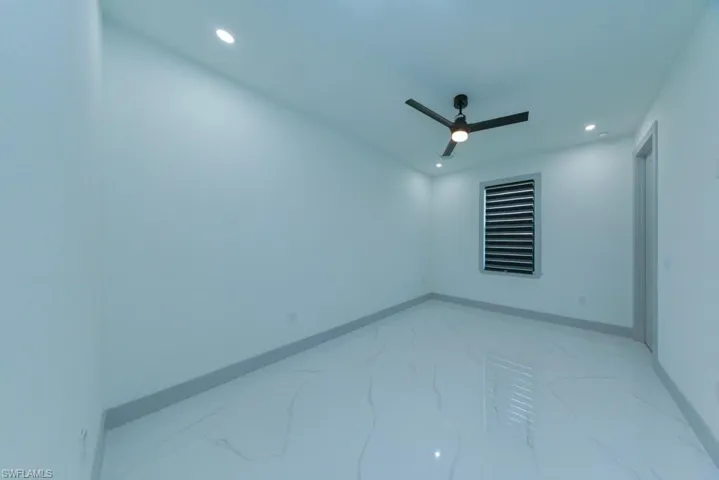 Unfurnished room with recessed lighting, ceiling fan, and light marble finish floors