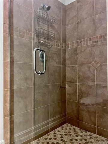 Bathroom with a stall shower, brand new door and toilet area with a pocket door