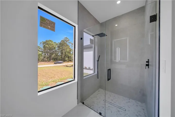 Bathroom featuring a stall shower and recessed lighting