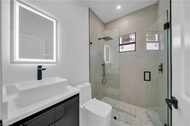 Full bath with vanity and a stall shower