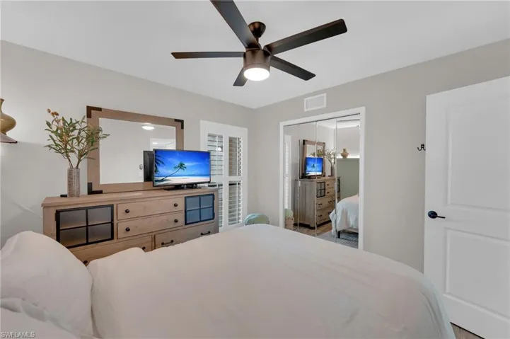 Bedroom featuring a ceiling fan and a closet
