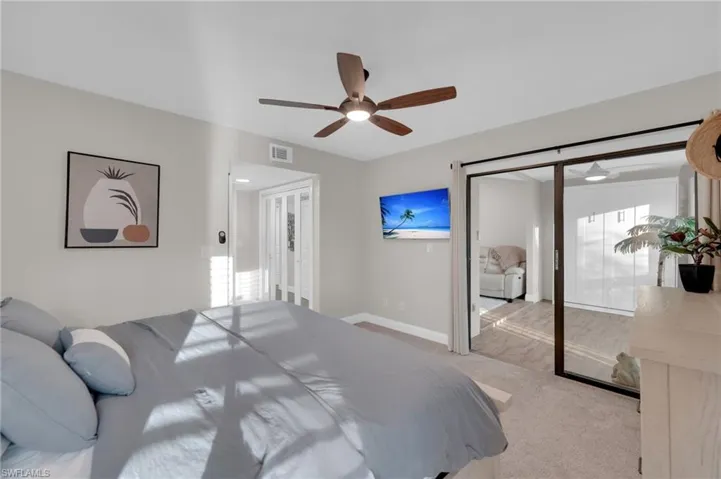Carpeted bedroom featuring baseboards and a ceiling fan