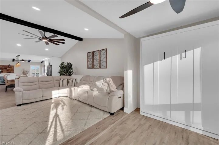 Living room featuring light wood-type flooring, a ceiling fan, and recessed lighting