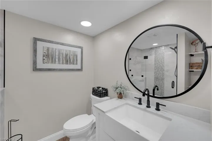 Full bath with vanity and a shower stall