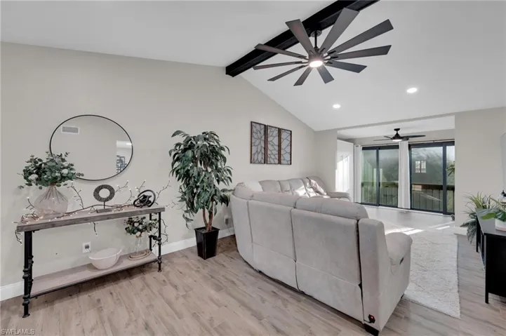 Living area with recessed lighting, light wood finished floors, and a ceiling fan
