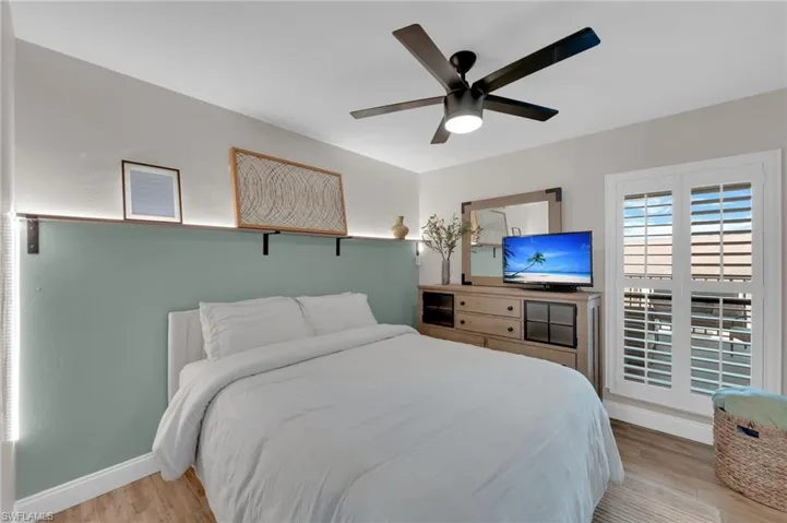 Bedroom with light wood-type flooring and a ceiling fan