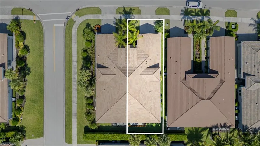 Aerial view of the home and surrounding area featuring property parcel outlined.