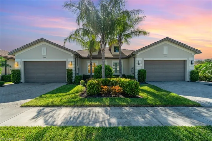 Villa home on the left, featuring 2 car garage, and beautiful landscaping.